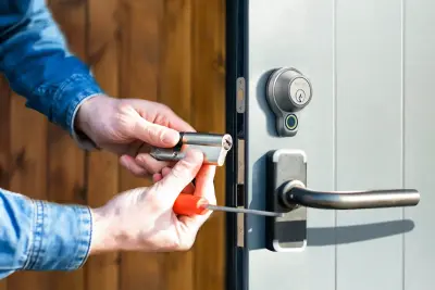 Technician rekeying a door lock for resident safety